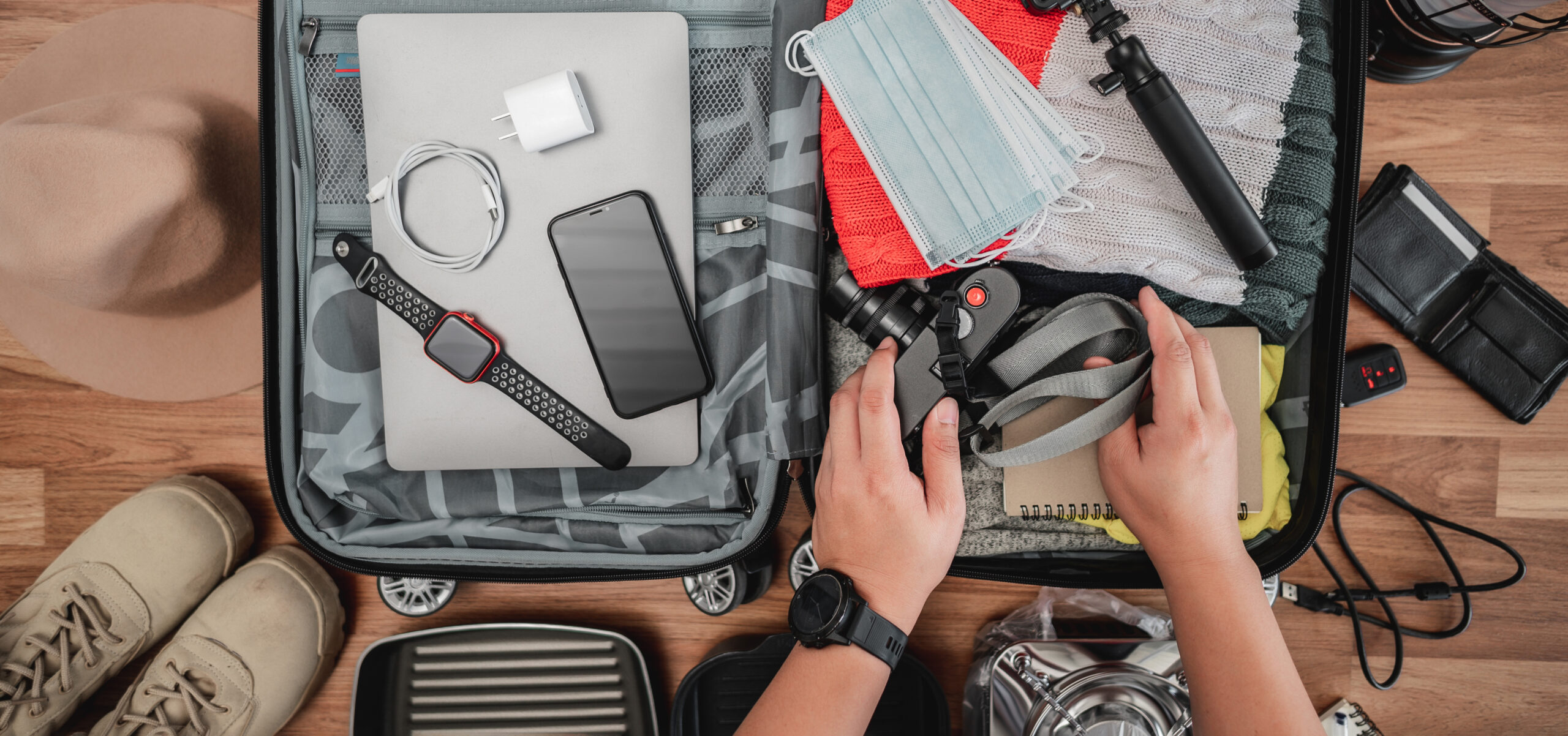 top view preparing suitcase summer vacation trip young man checking accessories stuff luggage travel holiday vacation concept scaled -